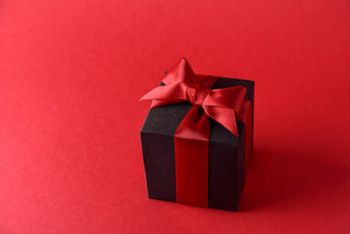 Black Present on a red background with a red ribbon