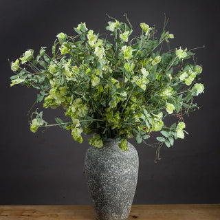 Green plants in grey ceramic vase