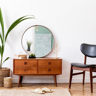 round mirror on a sideoboard