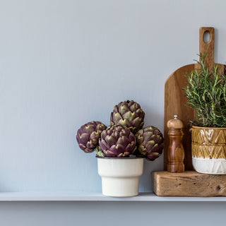 Chopping board against blue wall