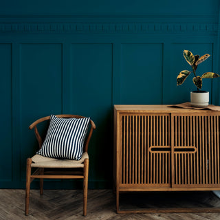 wooden furniture against a teal background