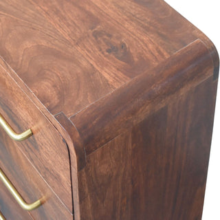 Close-up of the rounded waterfall edge where the dark wood top meets the side panel.
