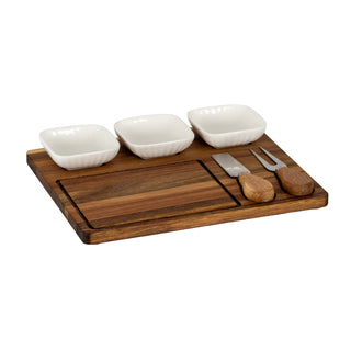 Acacia wood cheese board set with three white ceramic serving bowls and two wooden-handled cheese utensils.