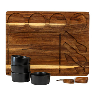Front-on view of the acacia board detailing the four bowl recesses and three knife cutouts.