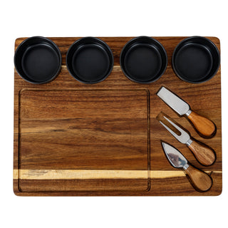 Rectangular acacia wood cheese board with four grey ceramic bowls set into the top edge and three cheese knives.