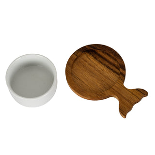Single white ceramic dip bowl beside a round acacia wood tray with a fishtail handle.