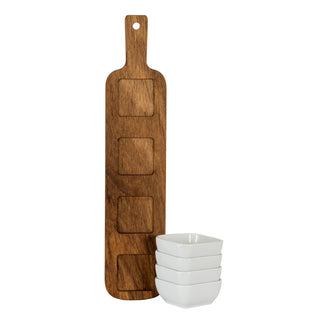 Acacia serving board standing vertically, showing four square recesses. Four white ceramic bowls are stacked beside it.