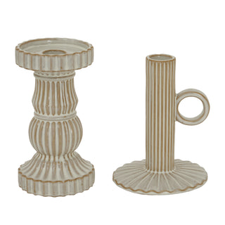 Pair of ribbed beige ceramic candle holders, one tall pedestal and one shorter handled design.