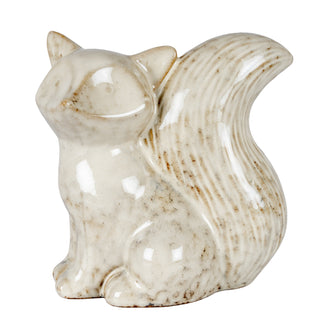 Speckled ceramic fox figurine sitting, looking left. The tail is textured. Plain product shot.
