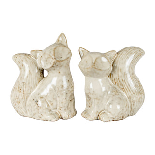 Two cream speckled ceramic fox decorations displayed together against a white background.