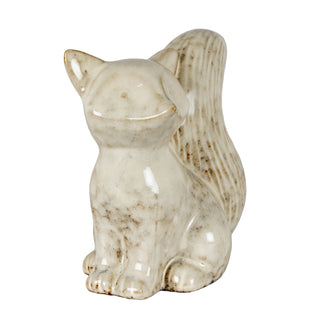 Rear three-quarter view of the speckled ceramic fox figurine, showing the upright textured tail.