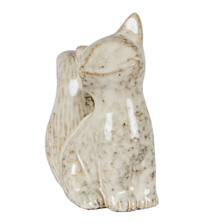 Speckled ceramic fox figurine viewed from the side, highlighting the glossy finish and sculpted tail.