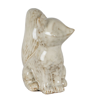 Side view of the ceramic fox showing the speckled beige and brown glaze finish and textured tail.