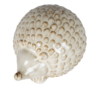 Close view of the ceramic hedgehog showing the textured spines and glossy cream and brown glaze.
