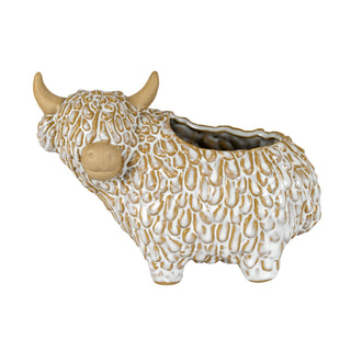 White and tan ceramic highland cow shaped planter, showing the textured glaze simulating fur.