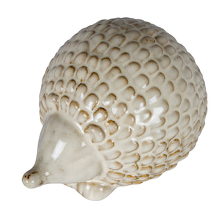 Side view of the round ceramic hedgehog decoration showing the pointed snout and textured quill pattern.