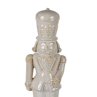 Detail shot of the ceramic nutcracker's head and uniform, showing the intricate moulding and gold embellishments.