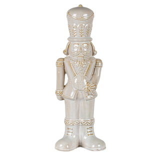 Plain front-on product shot of the ceramic nutcracker figure. Cream glaze with gold detailing on the uniform.
