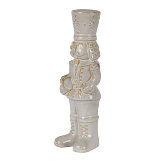 Profile view of the beige ceramic nutcracker showing the detailed uniform and drum held in front.