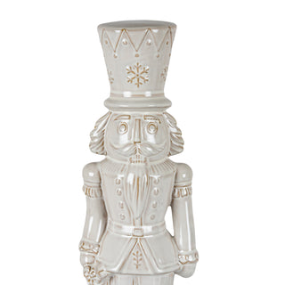 Front view close-up of the nutcracker figure showing the detailed face, uniform buttons, and hat with snowflake design.