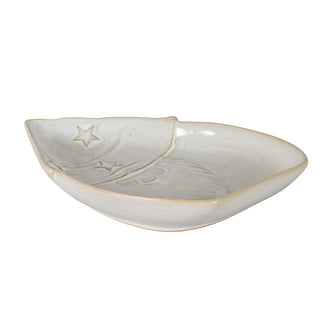 Off-white ceramic dish shaped like part of Santa's face, with embossed star and texture details. Plain studio shot.