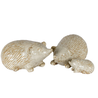 Grouping of three textured ceramic hedgehog figures demonstrating scale.