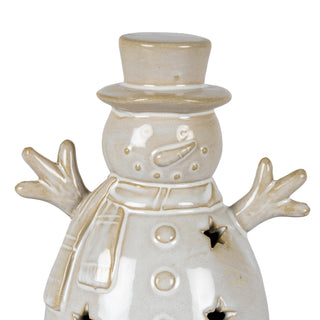 Detail shot of the beige ceramic snowman's head, top hat, and face with carrot nose and button eyes.