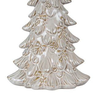 Close-up showing the glazed texture and gold detailing of the ceramic tree's raised bows and berries near the base.