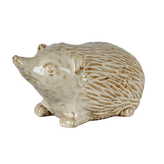 Small glazed ceramic hedgehog figure with textured quills, shown against a white background.
