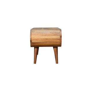End view of the coffee table showing the curved profile, wood grain, and tapered legs.