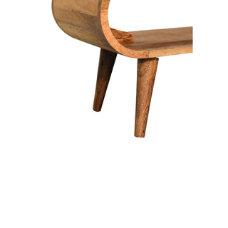 Detail of the coffee table base, highlighting the lower curved edge and the two angled, tapered legs.