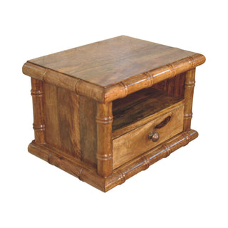 Amber oak nightstand shown at an angle, highlighting the single drawer with a round metal pull handle.