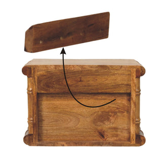 Amber oak bedside unit with the separate base plinth shown detached above the main body, illustrating assembly.