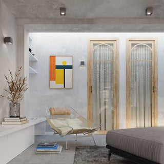 Anthracite quad ceiling lights installed in a modern bedroom setting with concrete walls.