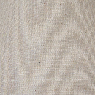 Close-up detail of the neutral linen lampshade fabric, showing the coarse weave and natural flecks.