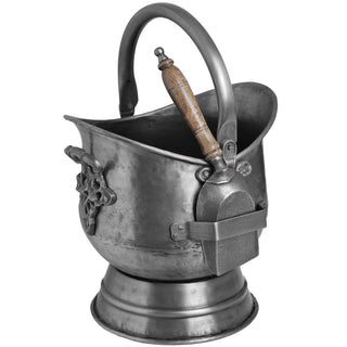 Antique pewter coal bucket with shovel attached, showing the ornate side handle and wooden shovel grip.