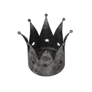 Distressed silver crown candle holder with star cutouts, viewed from a three-quarter angle.