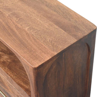 Detail of the media console's top surface, highlighting the rich wood grain and rounded edge profile.