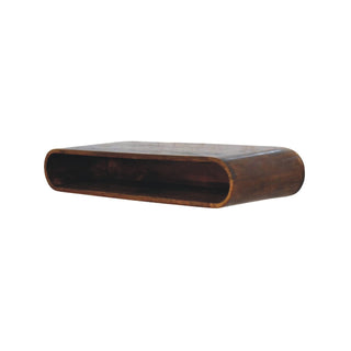 Dark wood arc media console, showing the continuous rounded shape and open storage cavity.