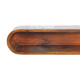 Close-up detail of the dark wood console's rounded end, showing the rich grain inside the storage cavity.