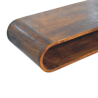 Close detail of the dark wood console's rounded front edge, showing the polished surface and grain.