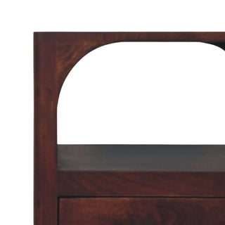 Close-up detail of the dark wood bedside table showing the curve of the arched recess.
