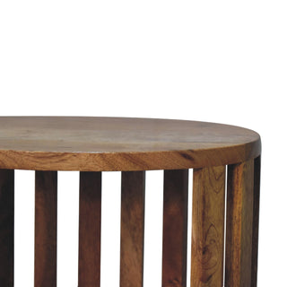 Close-up detail of the round wooden tabletop edge and vertical slatted sides.