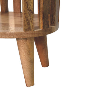 Detail shot showing the three tapered wooden legs attached beneath the round base.