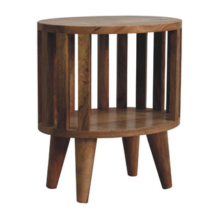 Angled view of the wooden bedside table showing the internal shelf structure and the three tapered legs clearly.
