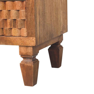 Lower corner detail of the teak bedside unit, highlighting the turned wooden legs and side panel.