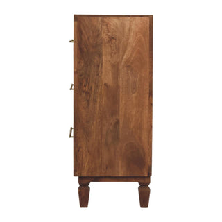 Full side view of the teak chest of drawers showing the wood grain and turned feet.