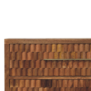 Detail view of the textured teak drawer front and the horizontal brass handle.