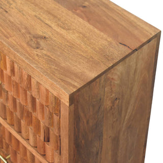 Close-up detail of the natural teak wood grain on the top surface and side panel of the chest.
