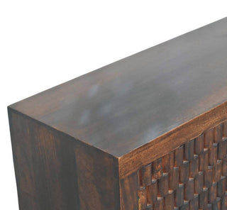 Detail shot of the chest's dark stained top panel and square corner joint.